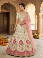 Woman wearing ivory embroidered lehenga set with blush pink net dupatta