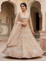 Woman wearing Pastel Blossom Embroidered Lehenga Set in beige gold with floral embroidery and pastel detailing