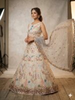 Elegant pastel lehenga set with embroidered net dupatta for wedding and festive wear